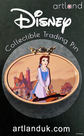 A collectable disney pin featuring the scene from Beauty and the Beast where Belle is walking over a bridge into town singing. 